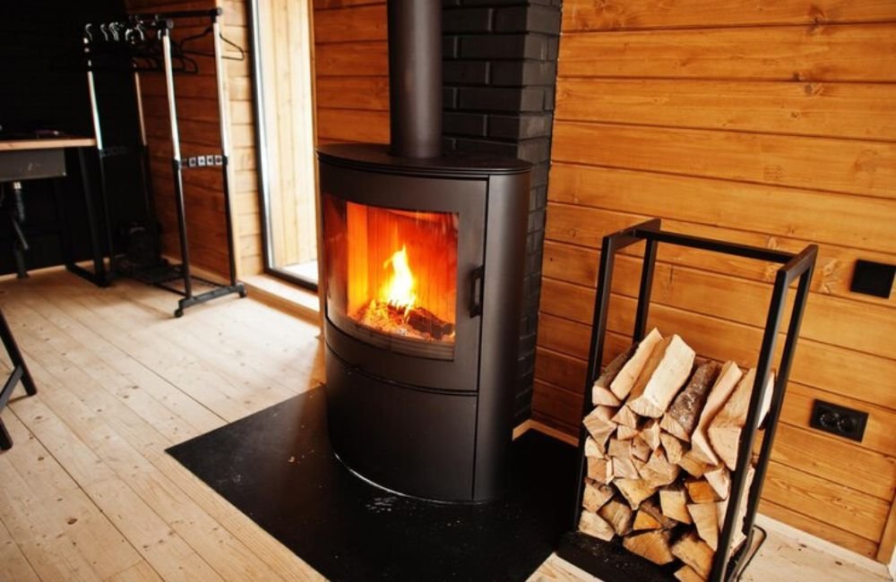 Covered deck with fireplace attached to house